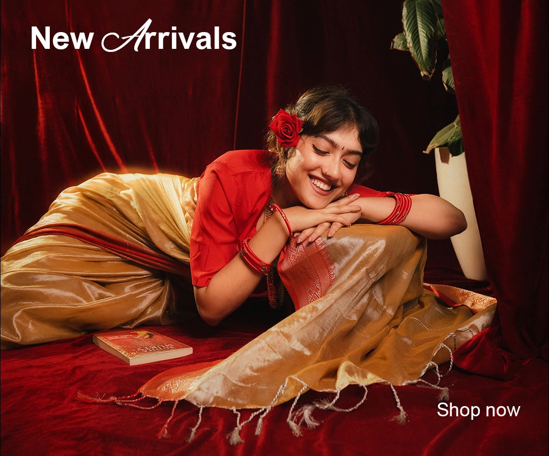 Close-up of handwoven golden fabric texture with red accent weave on traditional saree